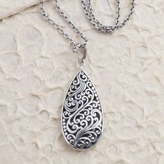 Bali's Yuniati engraves the pair-shaped pendant on this enchanting necklace with traditional Balinese designs. Crafted from sterling silver the necklace is equipped with a cable chain and completed with a combination finish. Engraved Sterling Silver Teardrop Pendant Jewelry, Traditional Silver Teardrop Necklace, Traditional Sterling Silver Teardrop Pendant Necklace, Ornate Carved Sterling Silver Jewelry, Intricate Teardrop Pendant Necklace As Gift, Teardrop Pendant Necklace With Intricate Design For Gift, Ornate Teardrop Necklace For Gift, Silver Engraved Teardrop Jewelry, Ornate Silver Teardrop Necklace