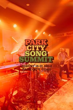 the band park city song summit is performing in front of an orange background with music equipment