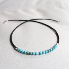 Simple and beautiful choker necklace made with 4mm genuine blue turquoise beads and 2mm matt black Miyuki seed beads, accented with 925 sterling silver beads. 925 Sterling silver lobster claw clasp. This necklace is safe to wear in water.  Turquoise is a purification stone.  It dispels negative energy and can be worn to protect against outside influences or pollutants in the atmosphere.  Turquoise balances and aligns all the chakras, stabilizing mood swings and instilling inner calm. Same design with natural AA tiger eye beads: https://www.etsy.com/listing/1706039166/natural-tiger-eye-bead-choker-necklace?click_key=b2ce19b3abb5404af01418b3319675e137e1bb18%3A1706039166&click_sum=2005b60a&ref=shop_home_active_6&pro=1&frs=1 Same design with genuine matte black onyx beads:  https://www.etsy.co Minimalist Blue Round Beads Choker, Minimalist Blue Choker With Round Beads, Minimalist Adjustable Blue Choker, Adjustable Turquoise Jewelry With Black Beads, Handmade Adjustable Black Turquoise Necklace, Minimalist Gemstone Beads Choker, Turquoise Jewelry With Black Beads, Minimalist Blue Beaded Turquoise Necklace, Minimalist Adjustable Turquoise Necklace