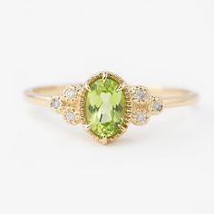 Unique art deco inspired oval peridot diamond ring comes in a 100% recycled 14k solid gold. Accentuated with three beautiful diamonds clustered on both sides complementing the bright color of peridot. Peridot is the birthstone for August and the 16th wedding anniversary gemstone. Purchase this as a special birthday gift or engagement ring for your special someone. This elegant ring will make every woman look and feel uniquely beautiful. * Stone: Ethically sourced genuine peridot * Stone size: ≈6 Peridot Engagement Ring, Peridot Engagement Rings, August Birthstone Ring, Woman Ring, Peridot Jewelry, Ring Halo, Family Jewellery, Peridot Stone, Gold Filled Ring