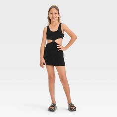 Your kiddo can layer their swimsuit while lounging on the beach or returning home from their swim session with this Solid Terry Cover-Up Dress from art class™. This sleeveless cover-up dress in a solid color features a center knot detail along with cutout sides and back for a stylish, breezy look. The cotton-blend terry fabric offers a cool and comfortable fit, while the pullover style allows for easy wear. Plus, the UPF 50+ rated finish offers added protection from UV rays. Welcome to art class