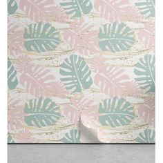 a pink and green wallpaper with palm leaves on the side, next to a gray floor