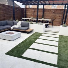 an outdoor living area with grass and white tiles