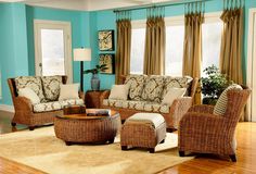 a living room with wicker furniture and blue walls