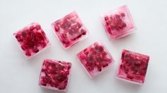 four square pieces of fruit sitting next to each other on top of a white surface