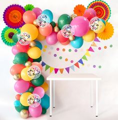 balloons and confetti are arranged in the shape of a letter