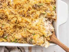 a casserole dish filled with chicken, cheese and broccoli