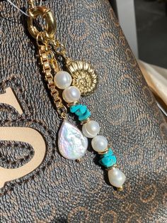 a close up of a purse with pearls and other items on the inside of it