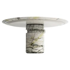 a white and black marble table with a circular base on the top that has an intricate design