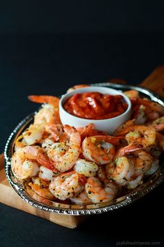 a plate full of shrimp with sauce on it