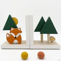 a wooden toy set with trees, mushrooms and a fox