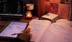 a person sitting at a desk with an open notebook and pen in front of them