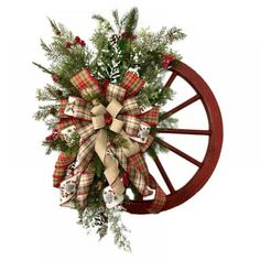 a christmas wreath on top of a wagon wheel