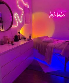 a bed room with a neatly made bed and neon lights