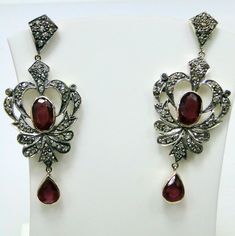 ITEM-VICTORIAN DIAMOND Ruby, 14 CT GOLD & STERLING SILVER EARRINGS. SIZE-5.5 /2.25 CM, TOTAL WEIGHT-13 GRAMS, Ruby WEIGHT-12 CT, OLD CUT FLAT ROUND DIAMOND WEIGHT-3 CT, 14 CT GOLD WEIGHT-3 GMS ALL STONES ARE NATURAL AND OF HIGH QUALITY. MATERIAL-14 CT SOLID GOLD , SILVER, DIAMOND ,Ruby. Luxury Silver Chandelier Earrings With Rose Cut Diamonds, Exquisite Gemstone Drop Diamond Earrings, Ornate Gemstone Earrings For Formal Occasions, Sterling Silver Hand Set Chandelier Earrings, Luxury Silver Diamond Earrings With Gemstone, Gold Ruby Earrings With Diamond Accents, Fine Jewelry Chandelier Earrings With Diamond Accents, Ornate Chandelier Earrings For Formal Events, Antique White Gold Drop Earrings