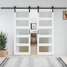 a white room with sliding glass doors and rug