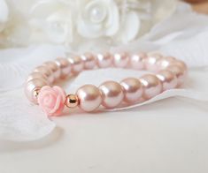 Flower girl bracelet, blush pink flower girl gift, pink rose bracelet, pearl bracelet, blush pink pearl bracelet, jr bridesmaid gift This blush pink flower girl bracelet is made with blush pink color little glass pearls (8 mm) and soft pink resin rose charm. This stretch pearl bracelet is perfect gift for your flower girls, jr bridesmaids or bridesmaids. Please visit my store to see the other wedding jewelry https://www.etsy.com/shop/asteriasbridal Pink Pearl Bracelet For Wedding, Delicate Pink Bracelets For Wedding, Delicate Pink Bracelet For Wedding, Delicate Pink Pearl Bracelet For Wedding, Feminine Rose Gold Bracelets For Wedding, Adjustable Pink Pearl Bracelet For Weddings, Pink Adjustable Bracelets For Bridesmaids, Dainty Pink Beaded Bracelets For Wedding, Dainty Pink Pearl Bracelets