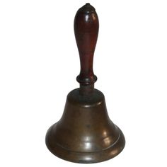 an antique brass bell on a white background