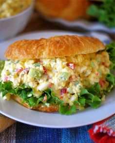 an egg salad sandwich on a croissant bun