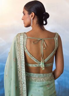 Elevate your elegance with the stunning Sea Green Sequinned Tissue Saree, meticulously crafted from premium tissue fabric. This exquisite sea green saree features a beautifully embellished border adorned with delicate crystal beadwork and sequins, adding a touch of sparkle to its ethereal charm. The lightweight tissue fabric drapes gracefully, creating a flattering silhouette. Paired with a matching blouse, intricately embroidered to complement the saree. A perfect ensemble for Mehendi, Sangeet, Cocktail and Reception and wedding guests. Composition : Saree and Blouse - Tissue Care: Dry Clean Only and Vacuum Storage This product can be customized for sleeves, length and colour Delivery : 6-8 weeks as the product is hand crafted. Check Size Guide or choose MySize for free customisation (All Tissue Blouse Designs, Sea Green Saree, Tissue Fabric, Tissue Saree, Vacuum Storage, Indian Wedding Wear, Green Saree, Draped Fabric, Wedding Guests