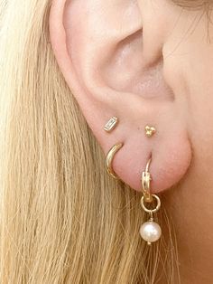 The perfect everyday earrings- now with genuine freshwater pearls! Our lightweight huggie hoop earrings measure about 12mm and are so comfortable, you'll never want to take them off! These simple beauties will never tarnish and can live life with you! 14k gold-filled hoops (pair) 6-7mm freshwater pearls Nickel Free, Hypoallergenic, and Lightweight Measures 12mm and made to gently hug your ear Signature Gift Packaging Included Everyday Pearl Charm Huggie Earrings, Everyday Pearl Charm Huggie Jewelry, Everyday Huggie Drop Earrings With Pearl, Everyday Huggie Jewelry With Pearl Charm, Everyday Hoop Earrings With Pearl Charm, 14k Gold-filled Huggie Hoop Earrings With Pearl Charm, Small Hoop Huggie Earrings With Pearl Drop, Everyday Small Hoop Huggie Earrings With Pearl Drop, Dainty Huggie Earrings With Pearl Charm For Everyday