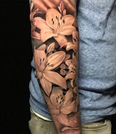 a man's arm with flowers on it