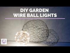 two wire ball lights sitting next to each other on a white surface with the words diy garden wire balls