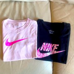 Girl’s Nike Shirts Pink Shirt Is Size Small Black Is Size Medium, Bnwt Nike Pink Top With Logo Print, Nike Pink Tops With Letter Print, Pink Nike Long Sleeve Tops, Nike Pink Long Sleeve Tops, Pink Nike Tops With Letter Print, Nike Pink T-shirt With Graphic Print, Pink Long Sleeve Nike Tops, Nike Pink Crew Neck Top, Pink Short Sleeve Shirt With Logo Print