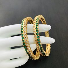 2.4, 2.6,2.8 Golden Green CZ bangles/Sabyasachi American diamond Green emerald bangles/CZ American diamond bangles @AryaFashions Features Traditional American diamond bangles Set Handcrafted To Perfection Light Weight Perfect For Indian Weddings And Celebrations A Beautiful & Memorable Gift for Weddings and Special Occasions Facebook: www.facebook.com/shoparyafashions Pinterest: www.pinterest.com/aryafashions Instagram: www.instagram.com/shoparyafashions Twitter: www.twitter.com/aryafashions Green Cutdana Bangle For Festivals, Green Bangle Jewelry For Diwali, Green Meenakari Bracelets For Celebration, Festive Green Bangle, Festive Green Round Bangle, Green Temple Jewelry Bracelets With Cutdana, Green Cutdana Bangle As A Gift, Green Temple Jewelry Bangle For Diwali, Green Cutdana Bangle As Gift