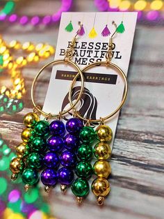 Mardi Gras themed bead earrings with hoops  I do not accept returns but if you have an issue with your earrings please let me know! Festive Nickel-free Dangle Hoop Earrings, Nickel-free Dangle Hoop Earrings For Festive Occasions, Green Hoop Earrings With Dangling Beads For Gift, Party Hoop Earrings With Dangling Beads, Green Dangle Hoop Earrings For Celebration, Hoop Earrings With Dangling Beads Gift, Hoop Earrings With Dangling Round Beads For Gifts, Hoop Earrings With Dangling Round Beads As Gift, Colorful Beads Dangle Hoop Earrings