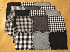 black and white patchwork quilts laid out on the floor