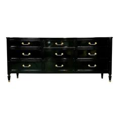 a black dresser with gold handles and drawers on it's sides, against a white background