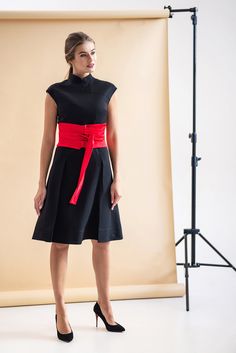 "A modern qipao dress featuring fit and flare silhouette, high neck mandarin collar and a midi length. - chinese (modern cheongsam) style - stand collar - short cap sleeves - skater pleated skirt - fabric buttons decoration - a-line silhouette - lined bodice - midi (Knee) length - concealed back zipper closure Fiber: 40% viscose, 55% polyester, 5% elastane Lining: 95 % viscose, 5 % elastane Color: black For size S: length- 40,5\" (103 cm) Our model wears size S (US 6) and is 171cm/5'6\" tall. Yo Elegant Spring Dress With Band Neckline, Elegant Summer Dress For Tea Ceremony, Elegant Knee-length Fitted Cheongsam, Elegant Fitted Knee-length Cheongsam, Elegant Knee-length Cheongsam For Formal Occasions, Spring Formal Knee-length Cheongsam, Elegant Black Cheongsam For Spring, Elegant Fitted Dress With Band Neckline, Stand Collar Dress For Spring Tea Ceremony