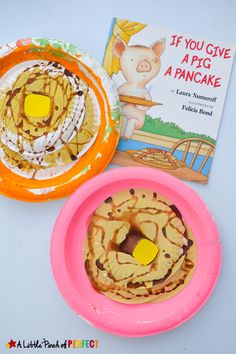 two plates with donuts on them next to a book about if you give a pig a pancake