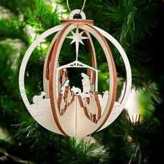 an ornament hanging from a christmas tree with a nativity scene in the center