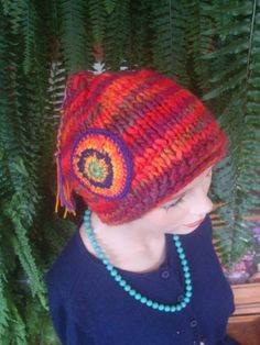 this cute pixie beanie is hand knitted with a tassel and a matching crocheted medallion Beanies Crochet, Pixie Bonnet, Red Pixie, Knitted Wool Beanie, Beanies For Women, Wool Beanie, Flower Clip, Knitting Women, Flowers In Hair