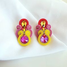 These colorful earrings are made using the Soutache technique, a type of embroidery used to sew beads and crystals with textile elements to create unique, particular and very light jewels. All the jewels in the shop are hand-sewn by me, in my small craft workshop in Italy. I select only the best materials to make the jewels and I protect them with an odorless and colorless impregnating agent so that they are resistant to dust and humididy.  DETAILS  * MODEL: Capri * MATERIALS: Italian Soutache, Pink Crystal Earrings, Super Duo, Toho Beads, Soutache Earrings, Soutache Jewelry, Types Of Embroidery, Jewellery Handmade, Handmade Jewelry Designs, Miyuki Beads