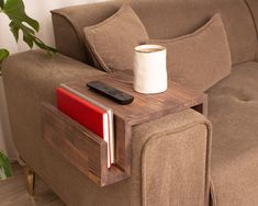 a coffee table with a remote control on it next to a couch in a living room