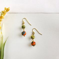 Two small Kantha textile beads are paired together to form this delicate, yet fluid silhouette.Measures 1 1/2" long; with nickel and lead-free ear wires. Each pair is handmade from recycled Kantha textiles, so colors and patterns will vary.Sustainably handmade by women artisans in India. Earthy Handmade Multicolor Earrings, Bohemian Green Beaded Earrings For Everyday, Green Bohemian Beaded Earrings For Everyday, Green Handmade Eco-friendly Jewelry, Earrings Fabric, Dangle Earrings Boho, Fabric Earrings, Beautiful Gift Wrapping, Beaded Drop Earrings