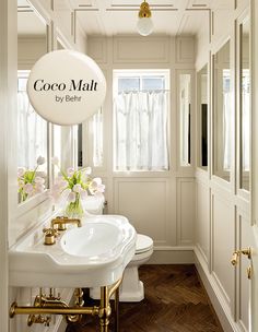 a bathroom with two sinks and a mirror above the sink that says coco mail by bern