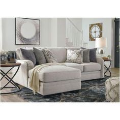 a living room scene with focus on the sectional sofa and pillows in the foreground