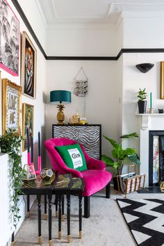 a living room filled with furniture and pictures on the wall next to a fire place