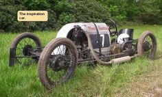 an old car is parked in the grass