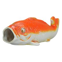 an orange and white fish figurine with its mouth open on a white background