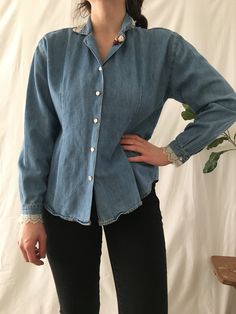 "Vintage 90s blue denim button-down shirt with lace detail on the collar and cuffs and 3 cute rose details on the lapel. Shirt is an unlined, lightweight denim with a relaxed fit. Fabric and care instructions not listed on the tag. Thread gone from the 3rd buttonhole.  Marked as a size Small. Model is 5'1 and usually wear a size small. Please refer to measurements for proper sizing. Shoulders- 18\" Bust- 38\" Waist- 36\" Length- 24.5\" Sleeves- 20\" If you have any questions about this item, please don't hesitate to ask! Thank you!" Fitted Vintage Button-up Denim Top, Classic Light Wash Denim Top For Spring, Classic Buttoned Denim Top For Spring, Classic Spring Denim Top With Buttons, Classic Cotton Denim Top For Spring, Classic Spring Denim Tops, Classic Long Sleeve Denim Top For Spring, Spring Denim Tops With Button Cuffs, Fitted Vintage Denim Top With Buttons