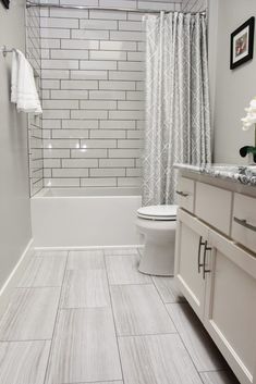 a bathroom with white and gray tile flooring