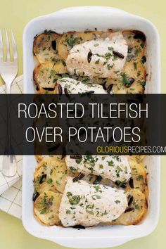 roasted fish over potatoes in a white casserole dish with herbs and cheese on top