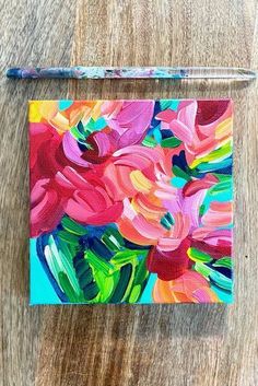 an acrylic painting of pink flowers on a wooden surface