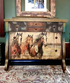 an old dresser with horses painted on it