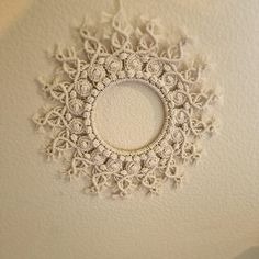 a white doily hanging from the ceiling